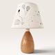 Wood-turned lamp with a hand-drawn lampshade, circus patterns.