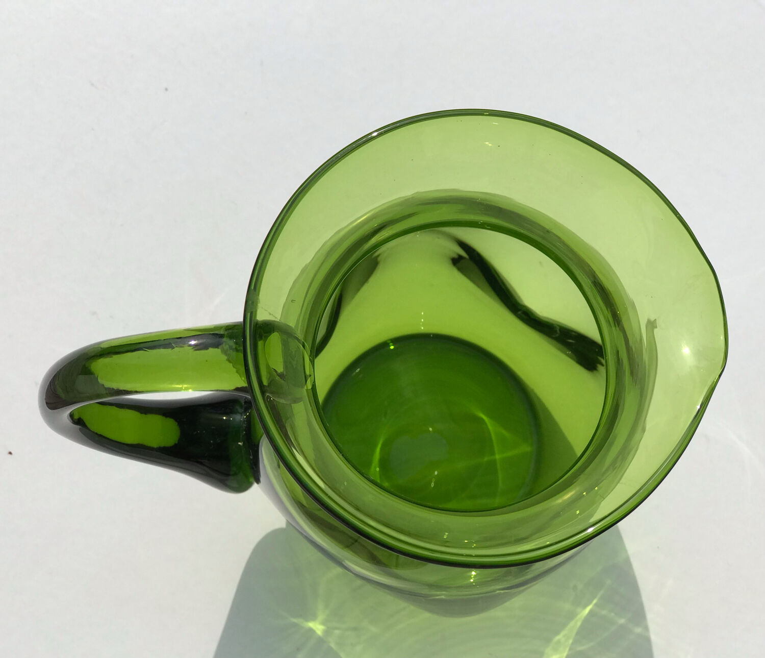 Green water jug in blown glass