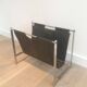 Magazine rack in brushed steel and leather, in the style of Poul Kjaerholm
