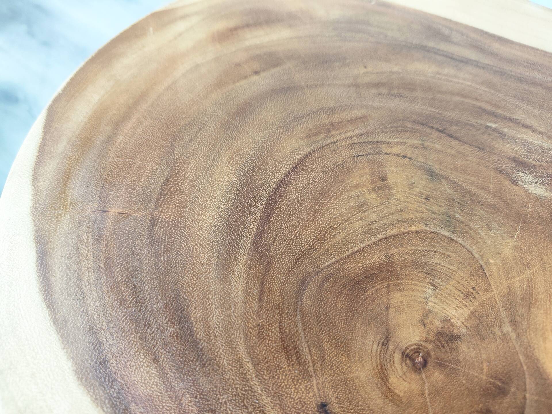 Minimalist side table in solid suar wood with conical legs.