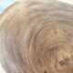 Minimalist side table in solid suar wood with conical legs.