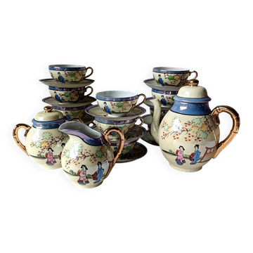 Vintage Japanese fine porcelain tea set with landscape pattern.