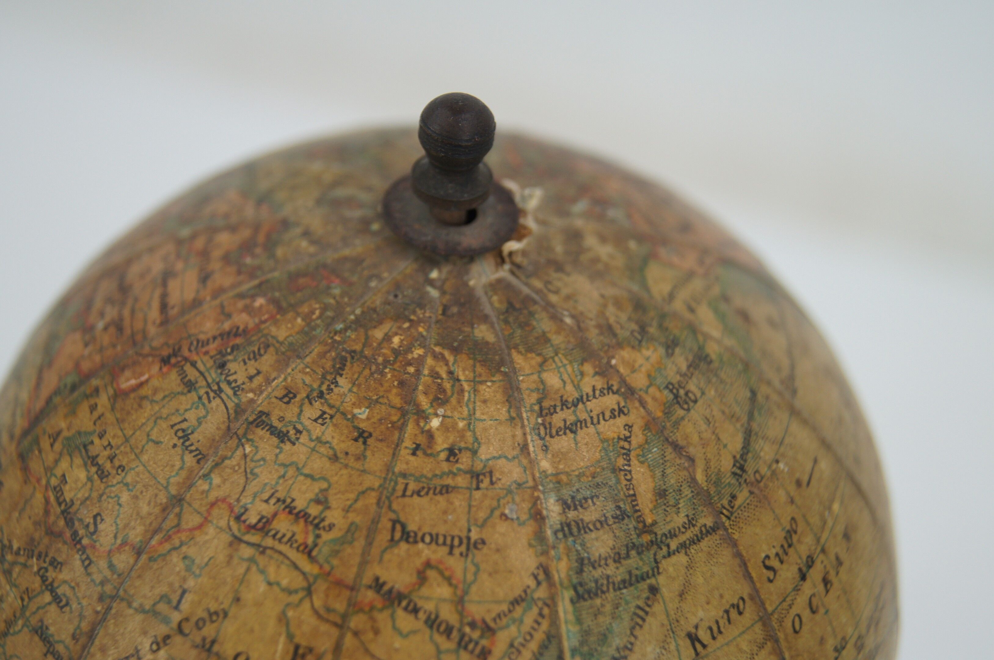 Globe on turned and blackened wooden base