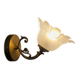 Frosted glass tulip wall sconces with brass arms.