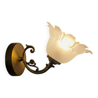 Frosted glass tulip wall sconces with brass arms.