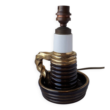 Ceramic lamp base in the shape of a candlestick.