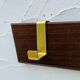 Vintage wooden and brass coat rack with 3 hooks from the 1960s.