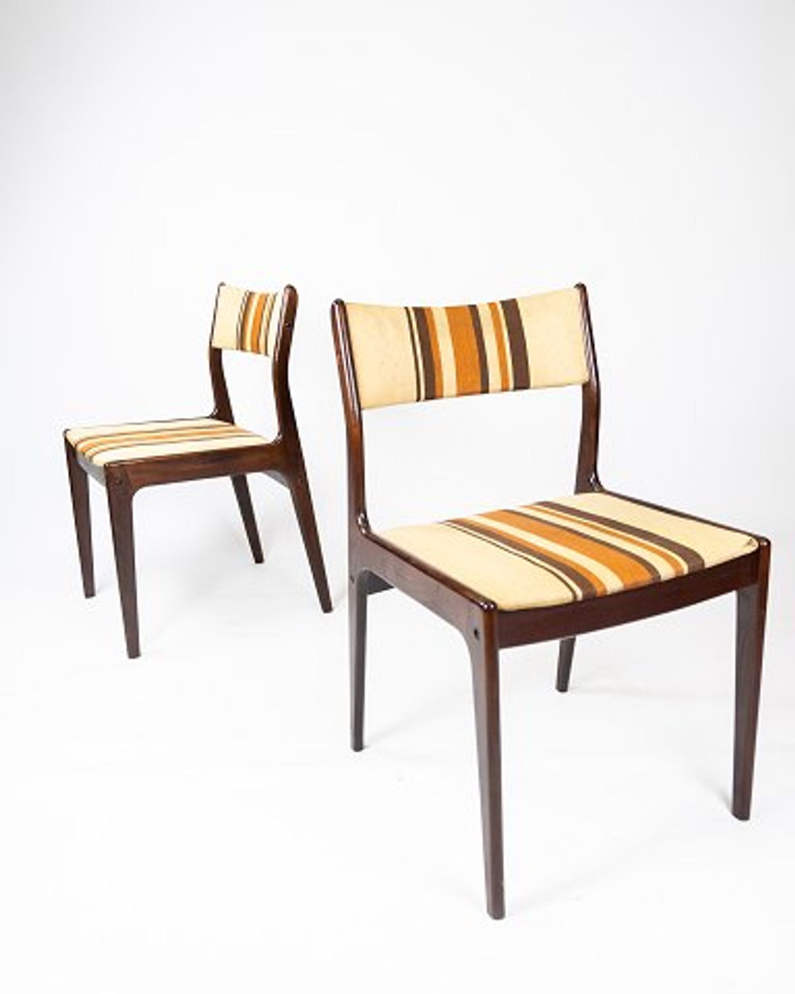 Pair of chairs in dark wood upholstered with light striped fabric of danish design