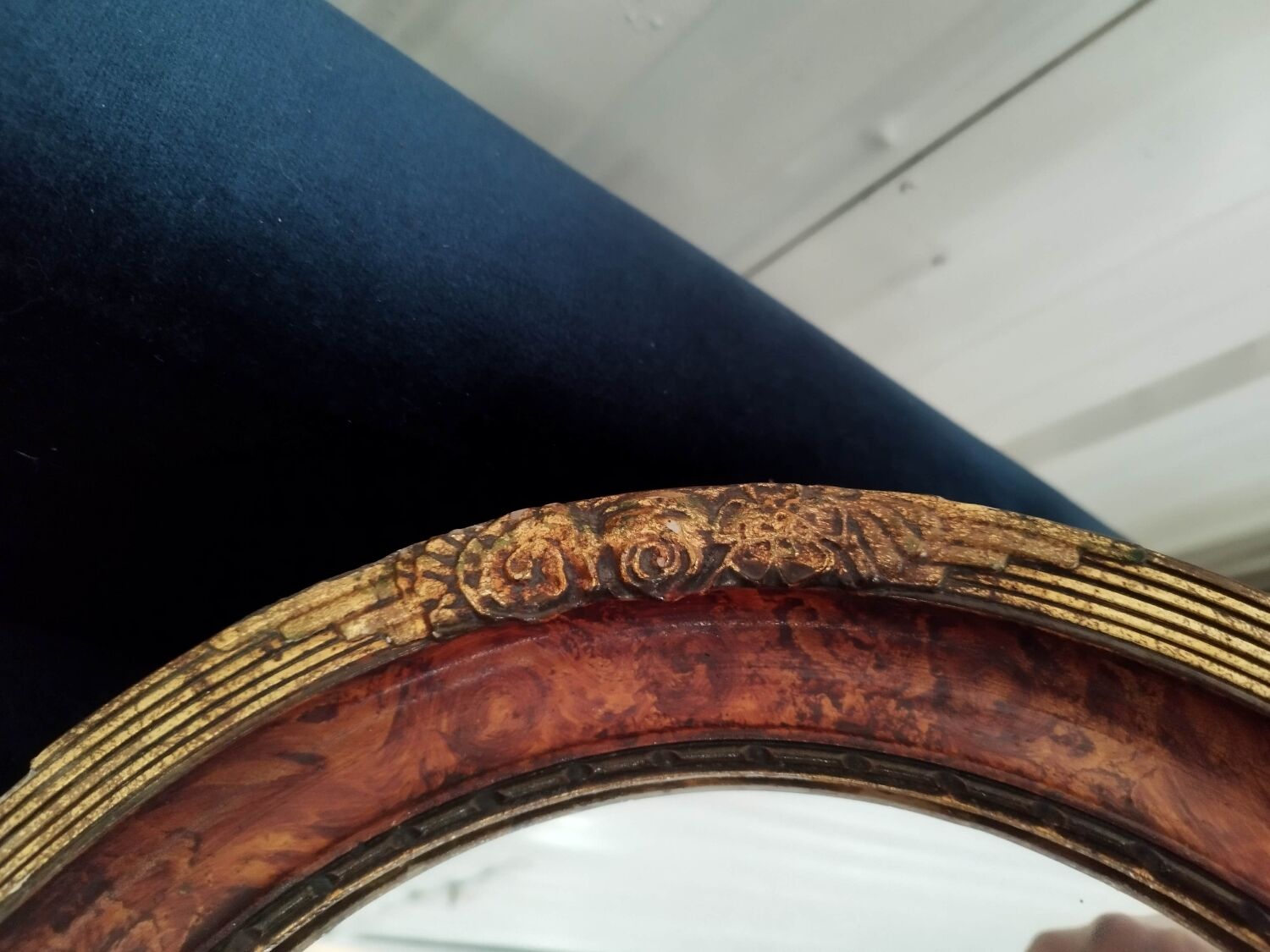 Golden oval art deco mirror