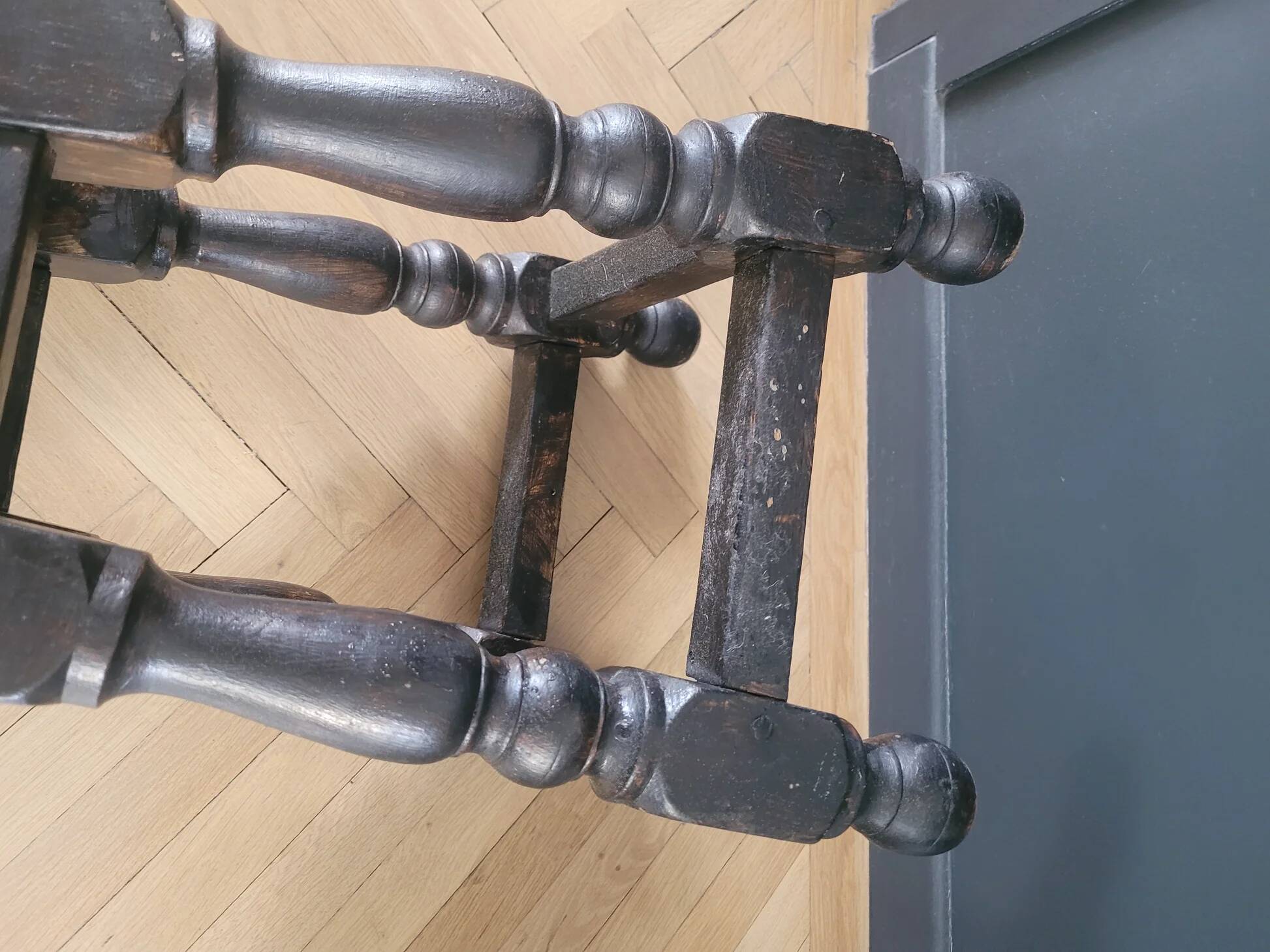Antique wooden stool with turned legs.