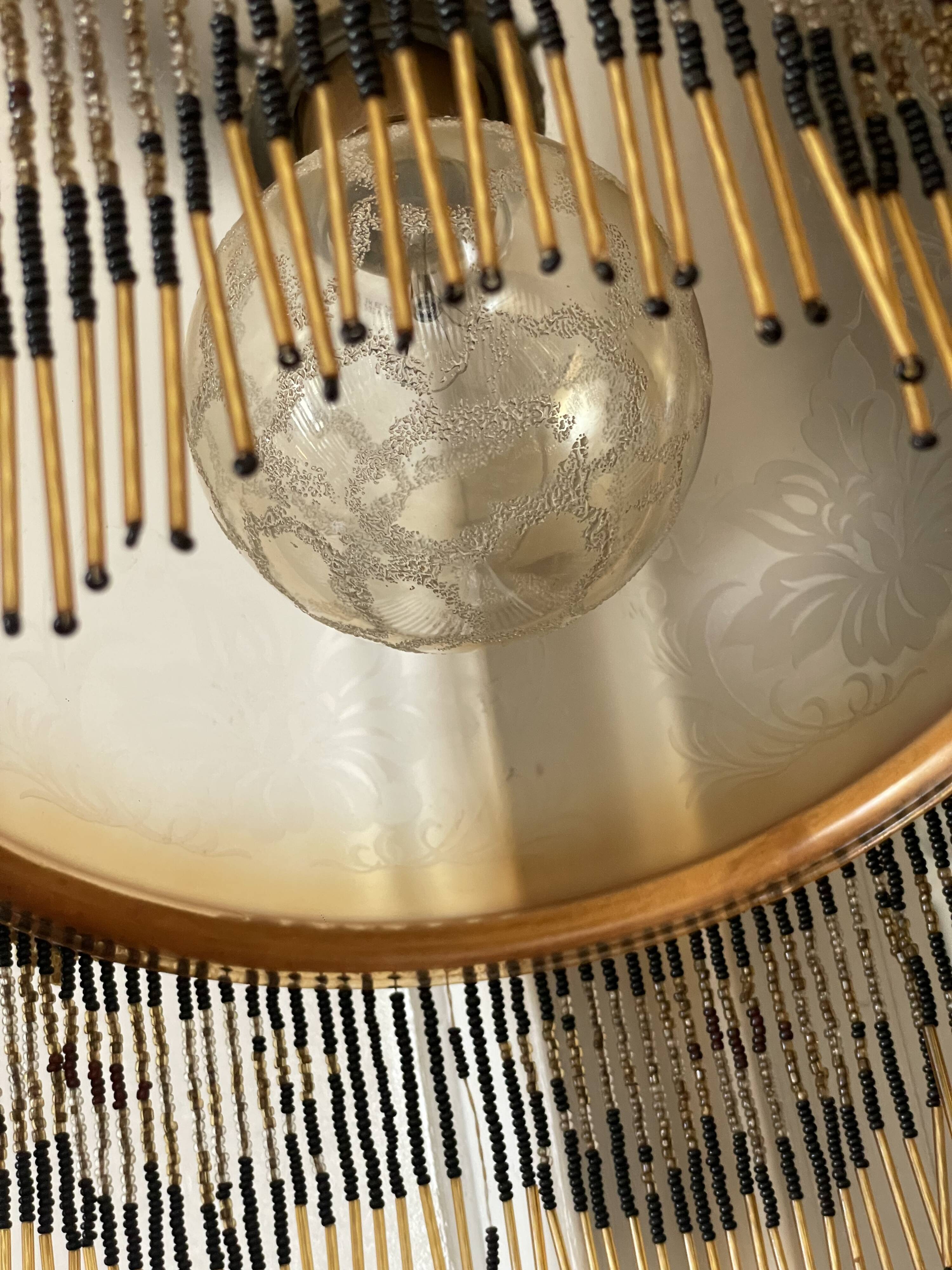 Glass lampshade and pearl tassels