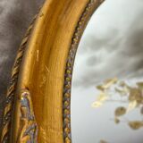 Oval-shaped gilded wooden mirror
