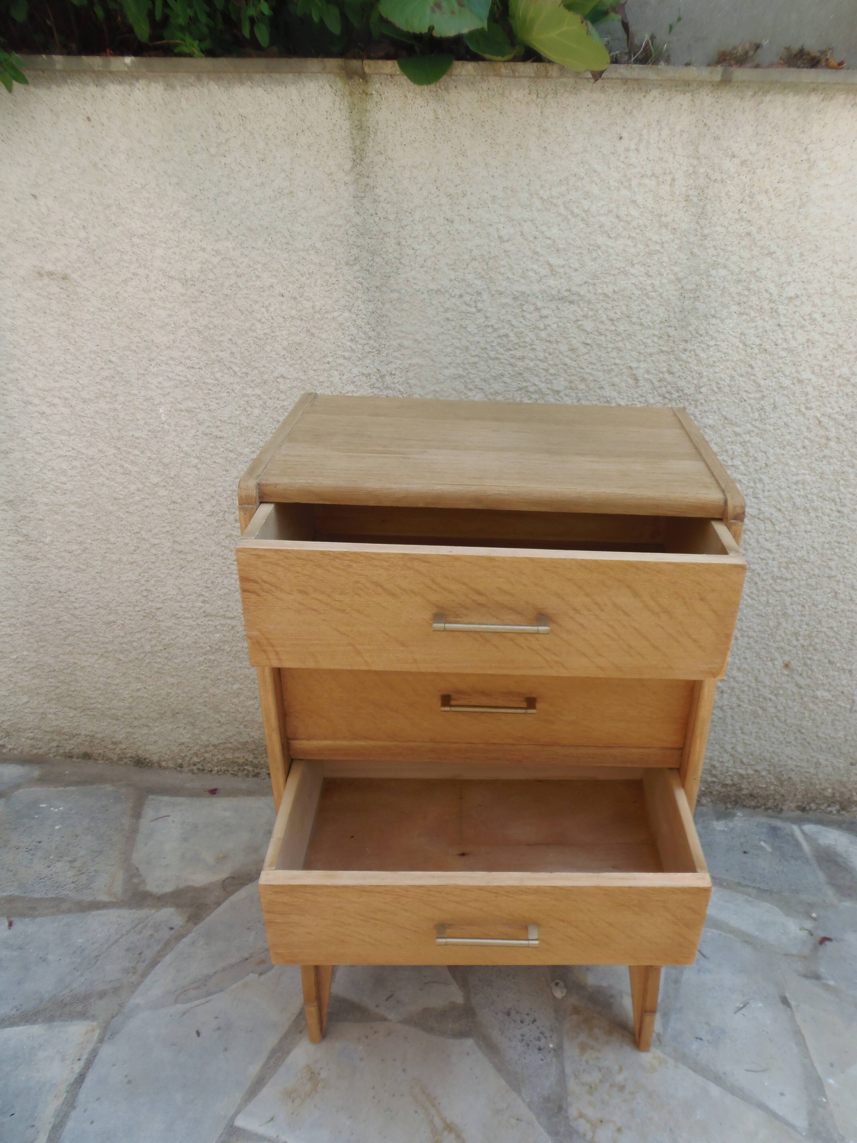 Vintage chest of drawers in raw wood.