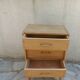 Vintage chest of drawers in raw wood.