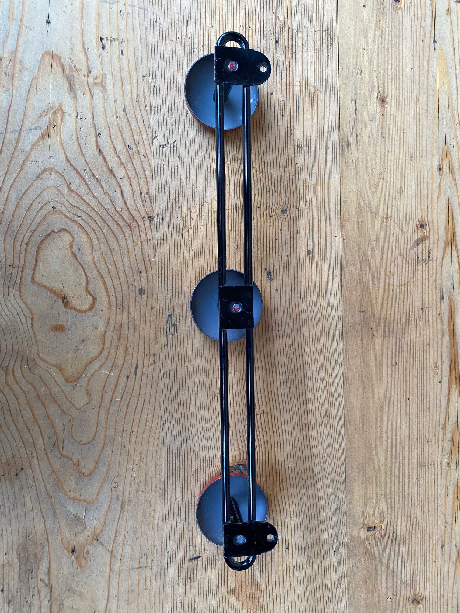 Wall coat holder in vintage red metal.