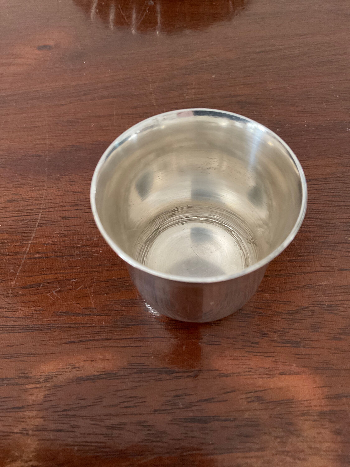 Cup and silver metal saucer