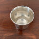 Cup and silver metal saucer