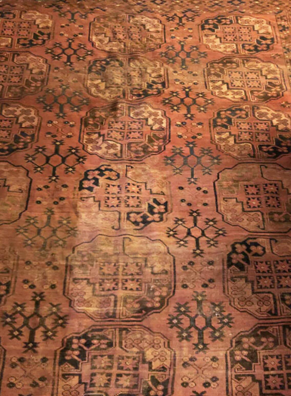 Antique Afghan/Turkmen wool rug, gul patterns, red and brown tones.