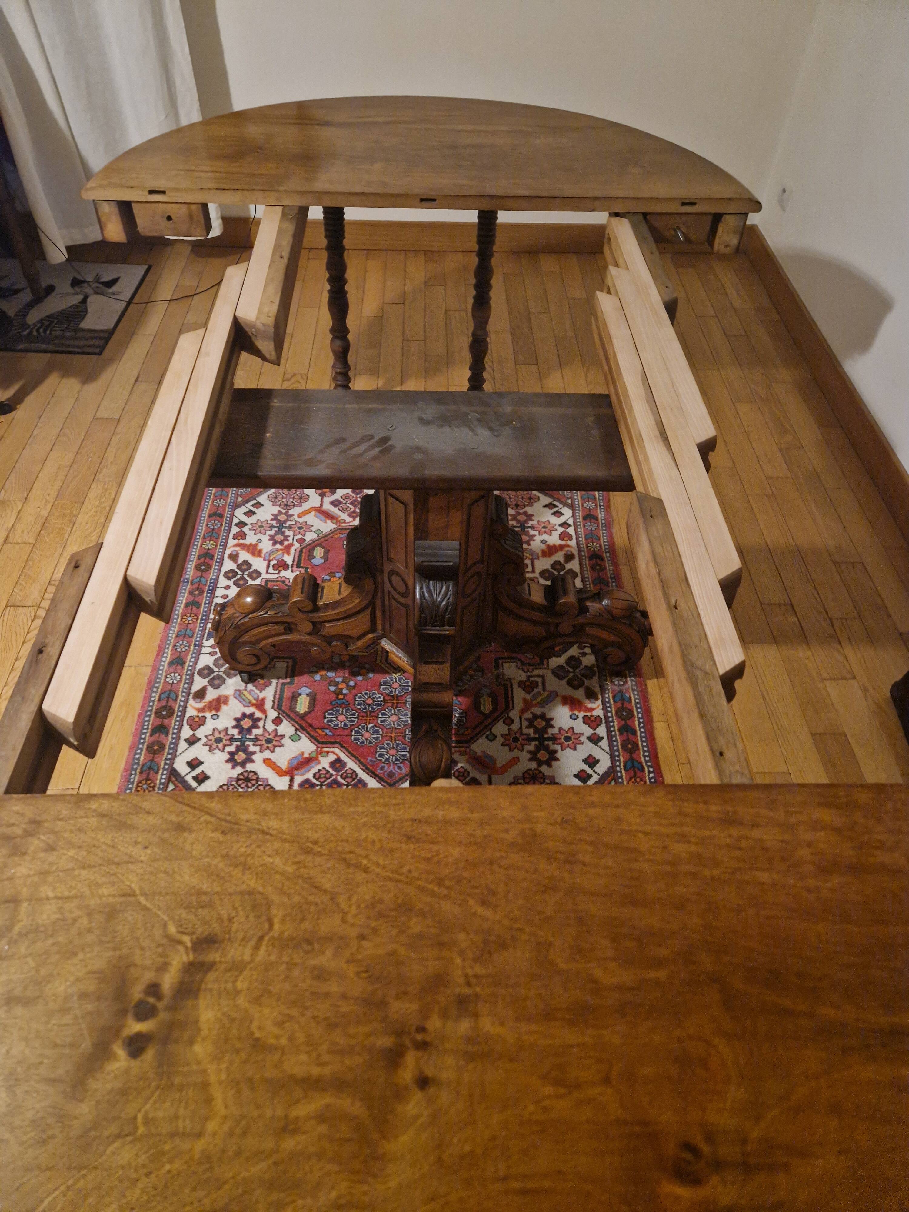 Round walnut table in solid wood, Napoleon III style with extensions - for 14 settings.