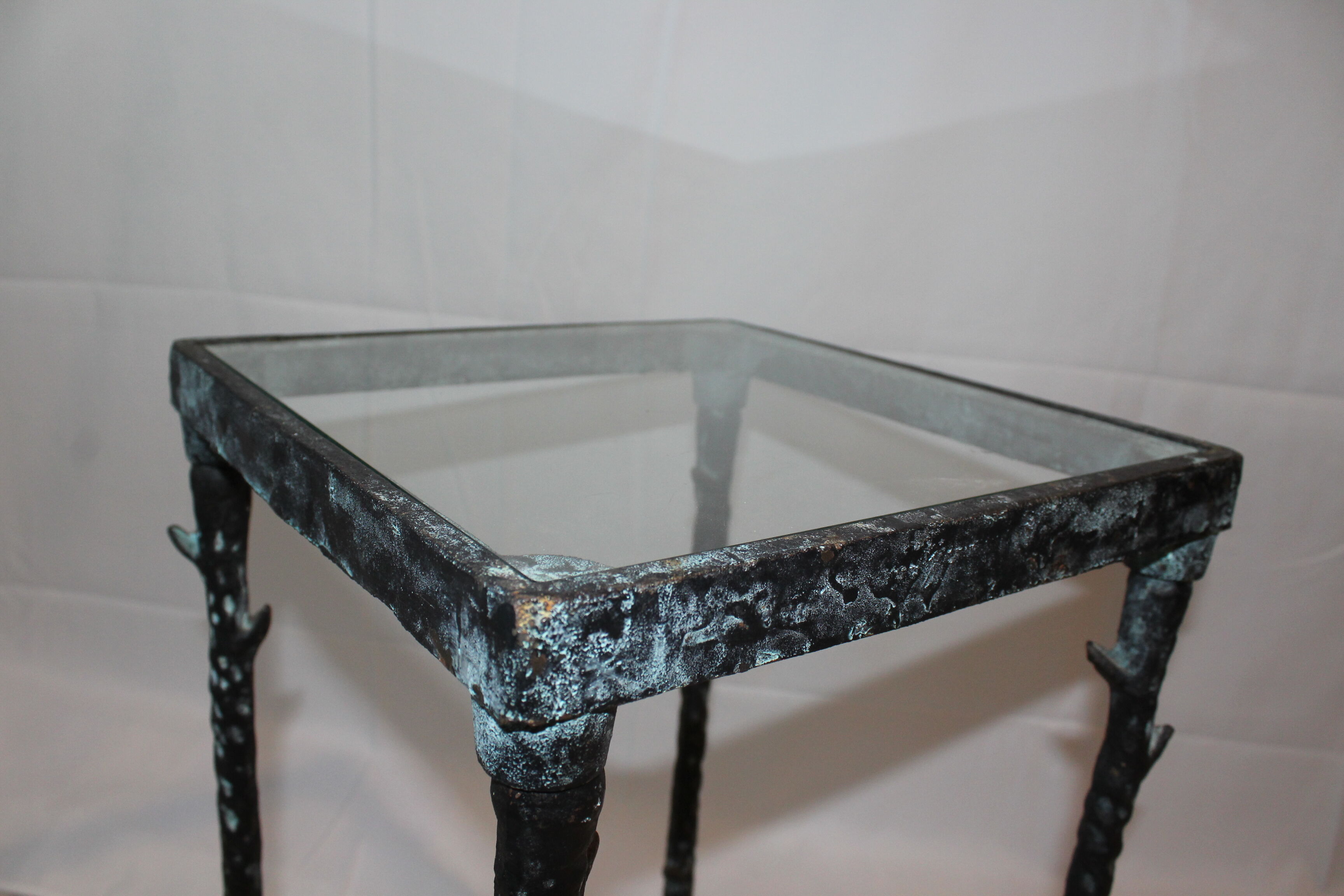 Giacometti style cast iron table, glass table