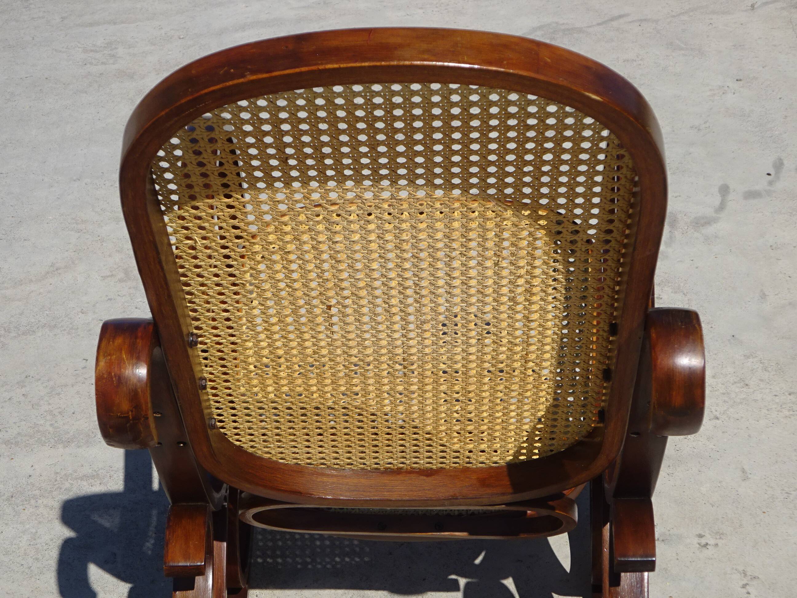 Vintage wooden rocking chair with caning