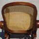 Vintage wooden rocking chair with caning