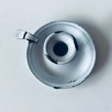 Old candle holder in white enameled metal