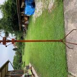 Vintage red industrial coat rack in cast iron, 1950s style, tripod base.