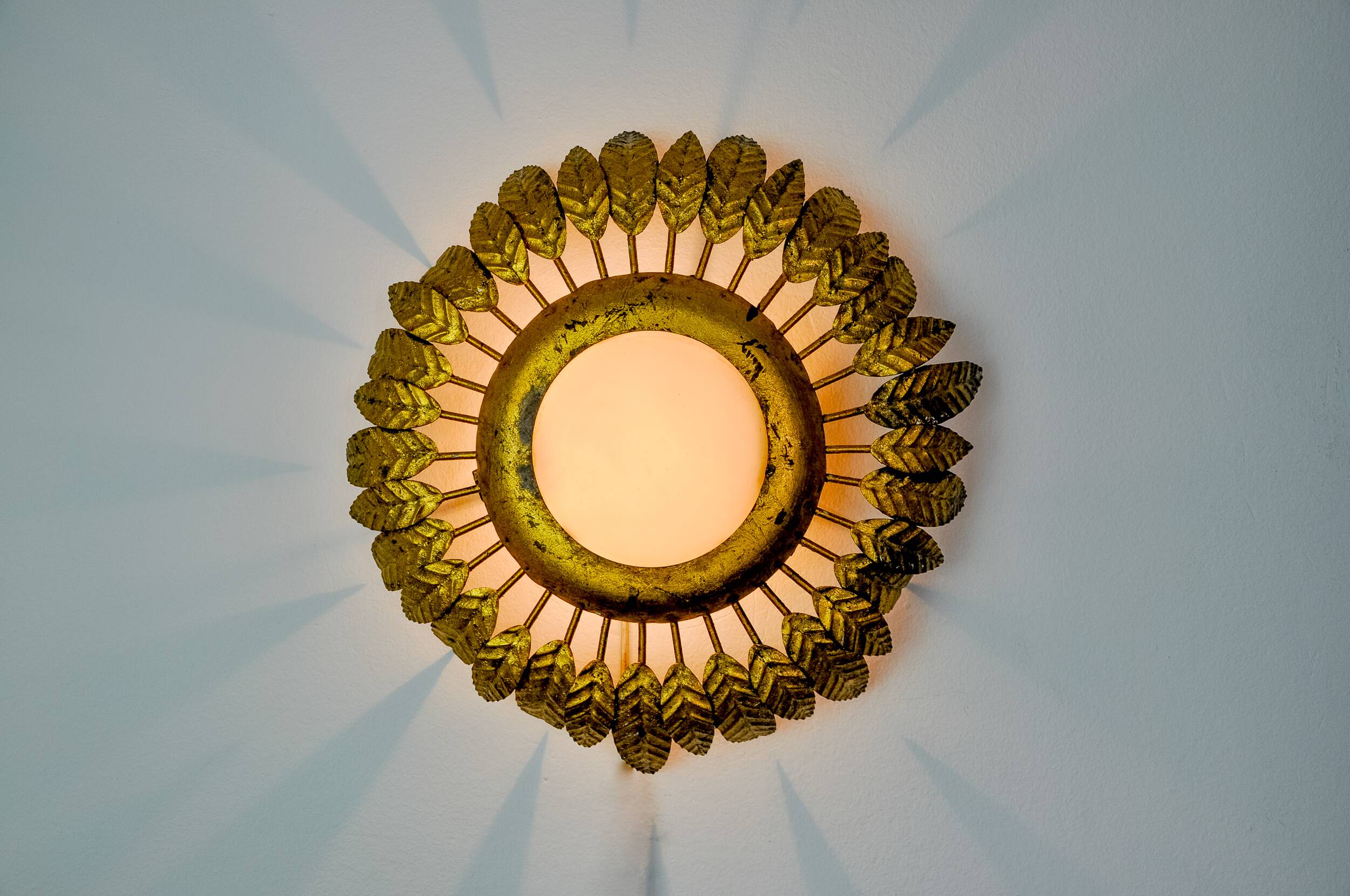 Sun wall lamp by ferro arte, metal and gold leaf and opaline glass, Spain, 1960