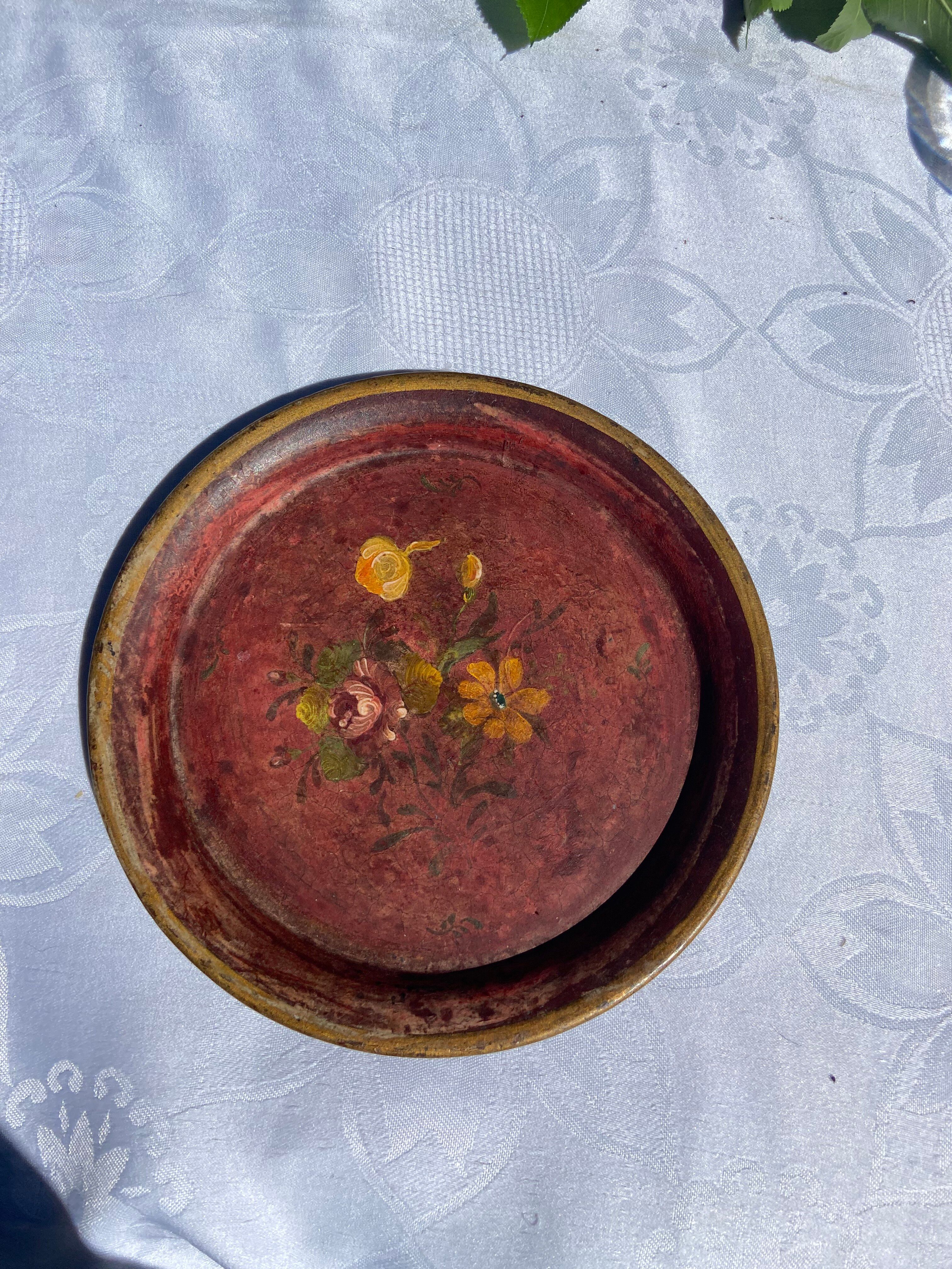 Small antique lacquered dish with hand-painted floral decoration.