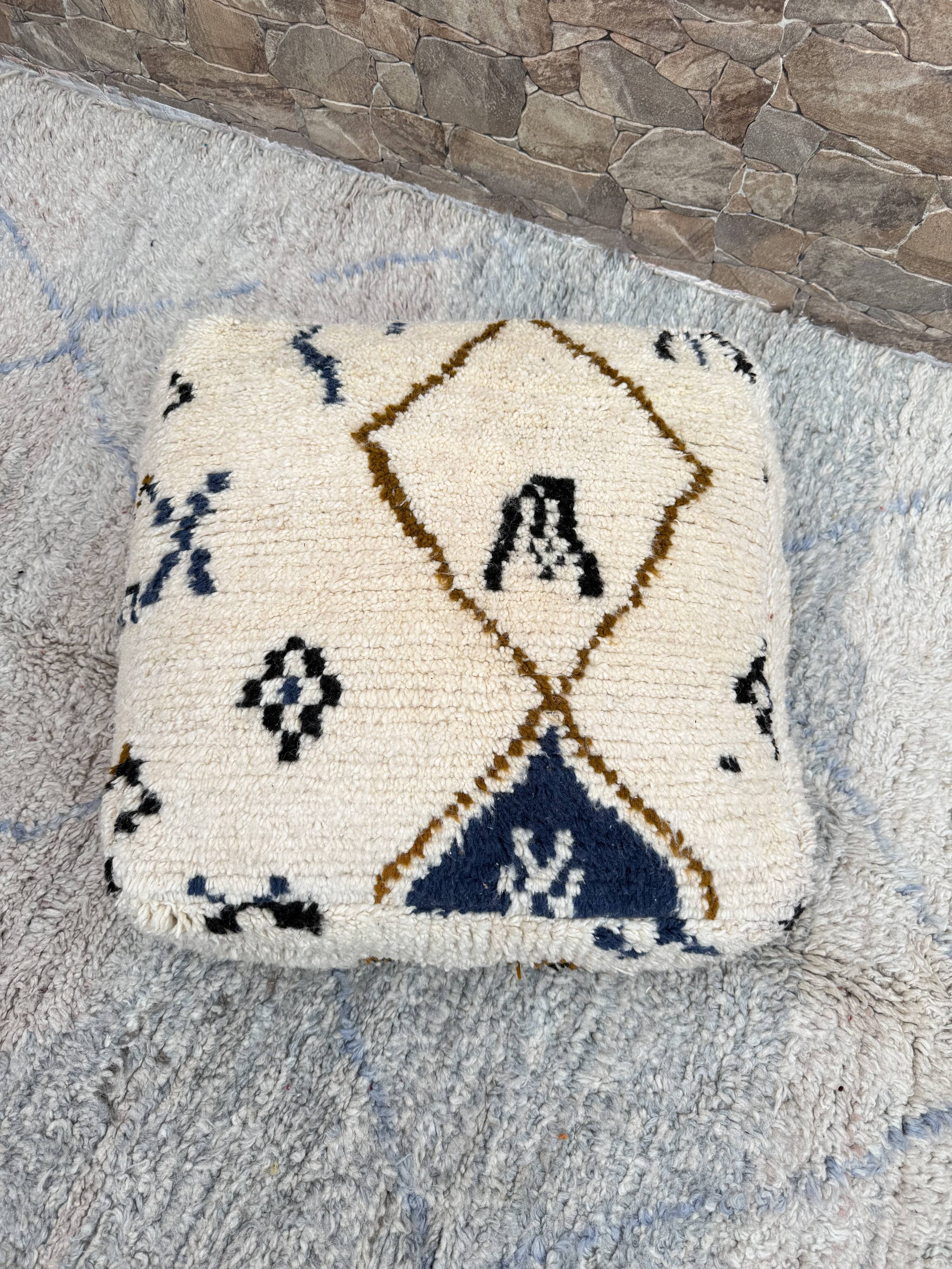 Berber floor pouf: Handwoven Moroccan wool cushion.