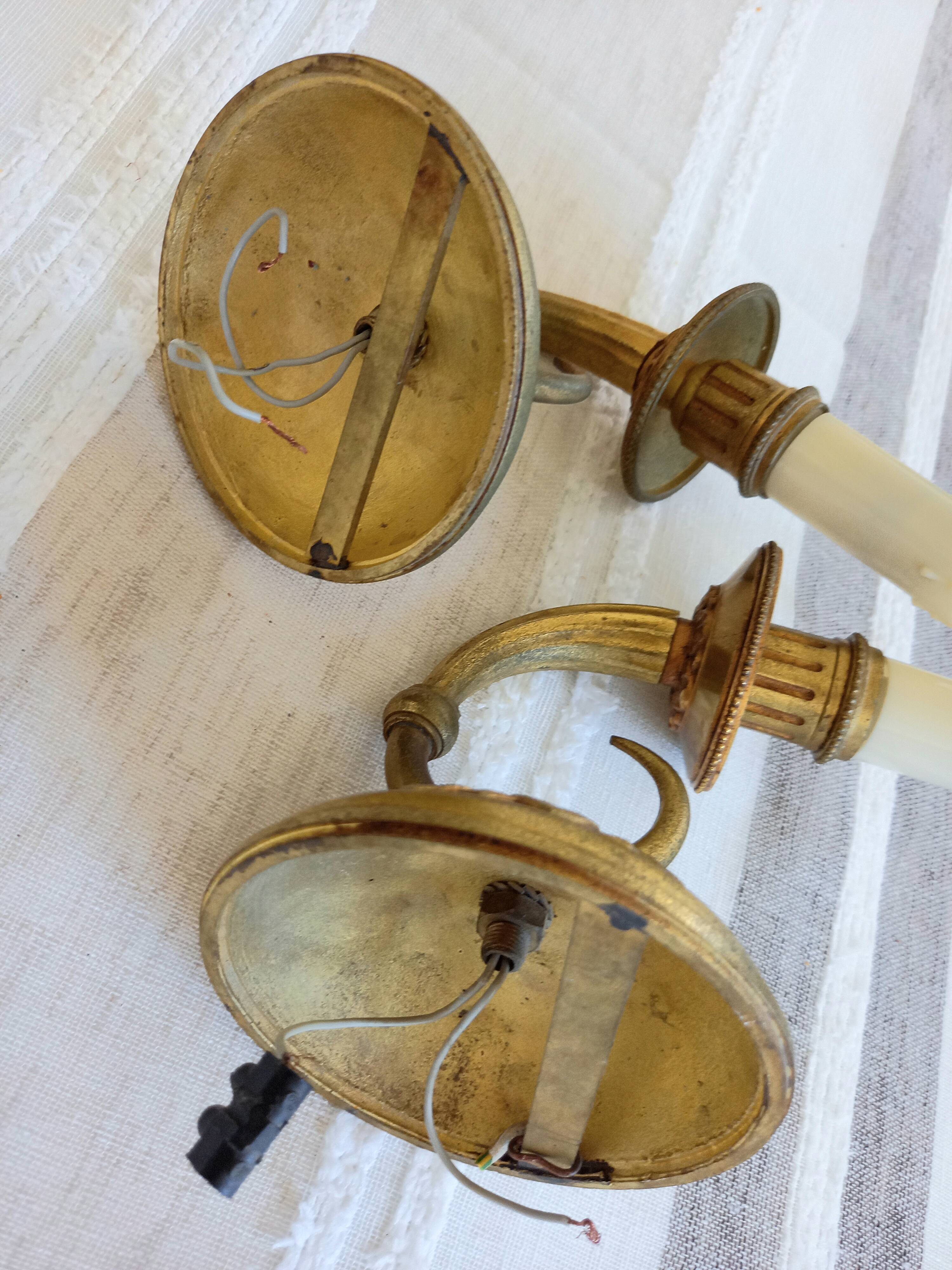 Electrified bronze gold wall sconces... in pairs.