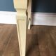White retro wooden commode in Mid-Century style, tapered legs and gold handles (1960s)