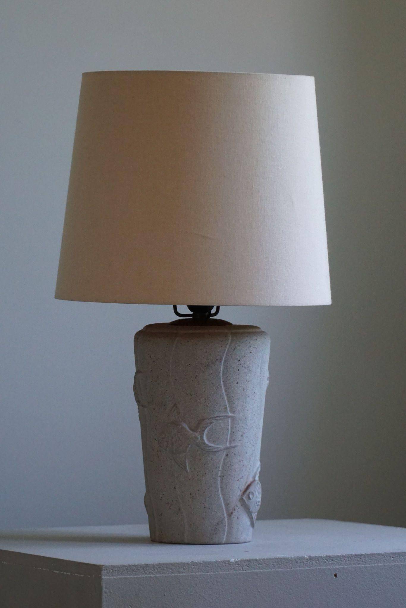 Modern vintage French table lamp, made of stone with fish patterns, 1970s.