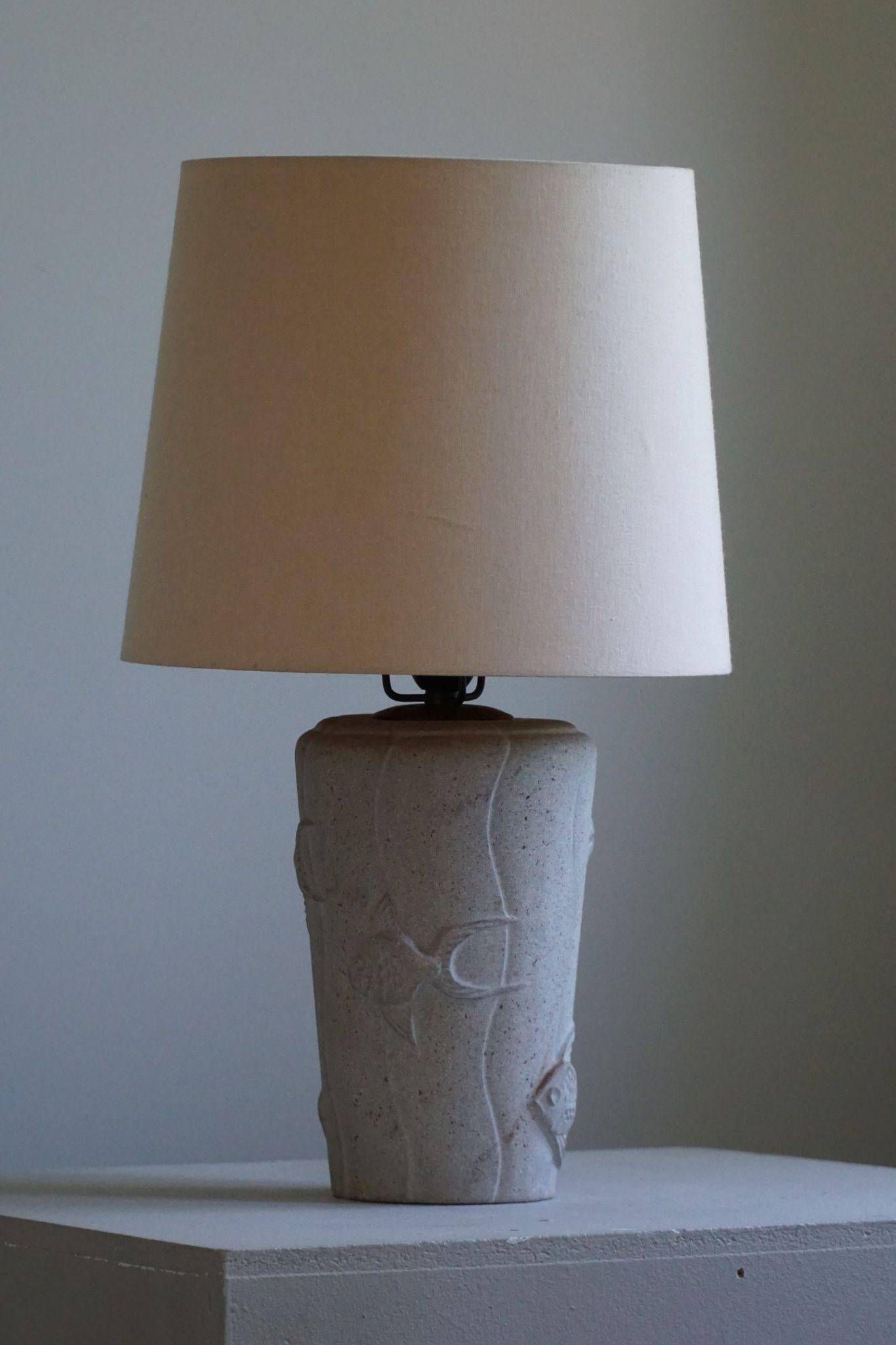 Modern vintage French table lamp, made of stone with fish patterns, 1970s.