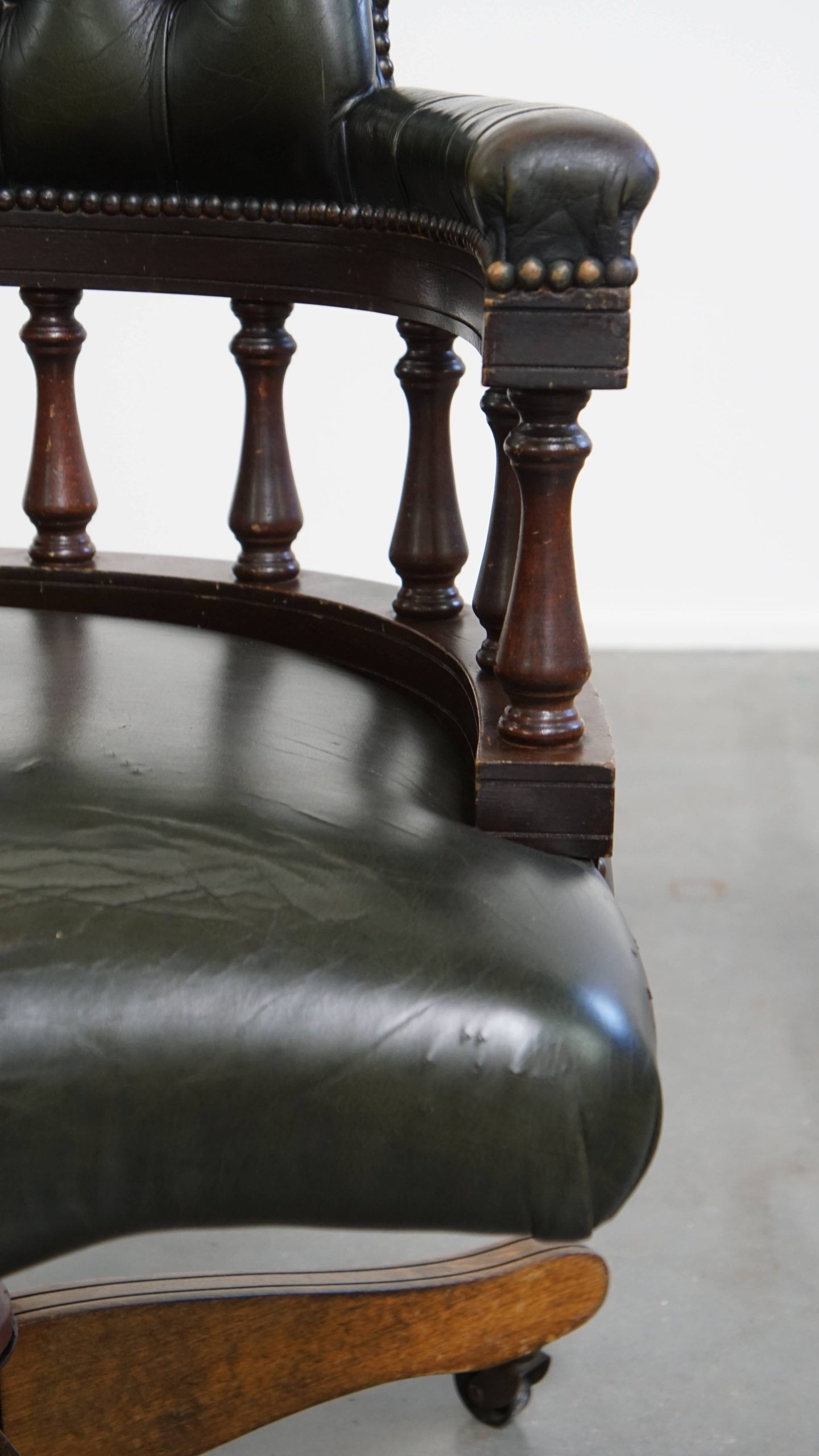 Adjustable green leather and wood Chesterfield office chair with swivel