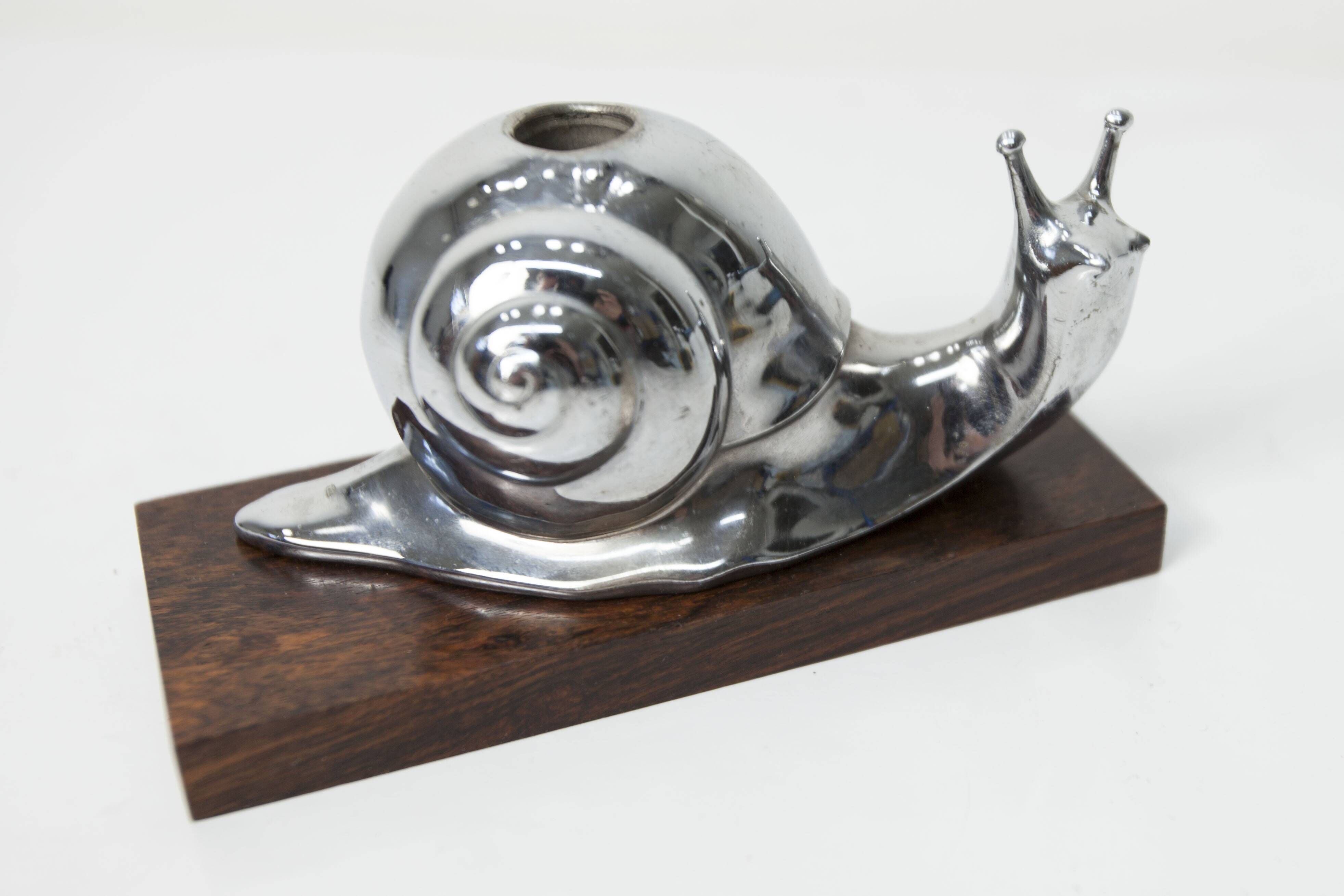 Silver snail candlestick on a teak base 1960
