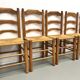 Set of 8 chairs in solid elm with straw seats.