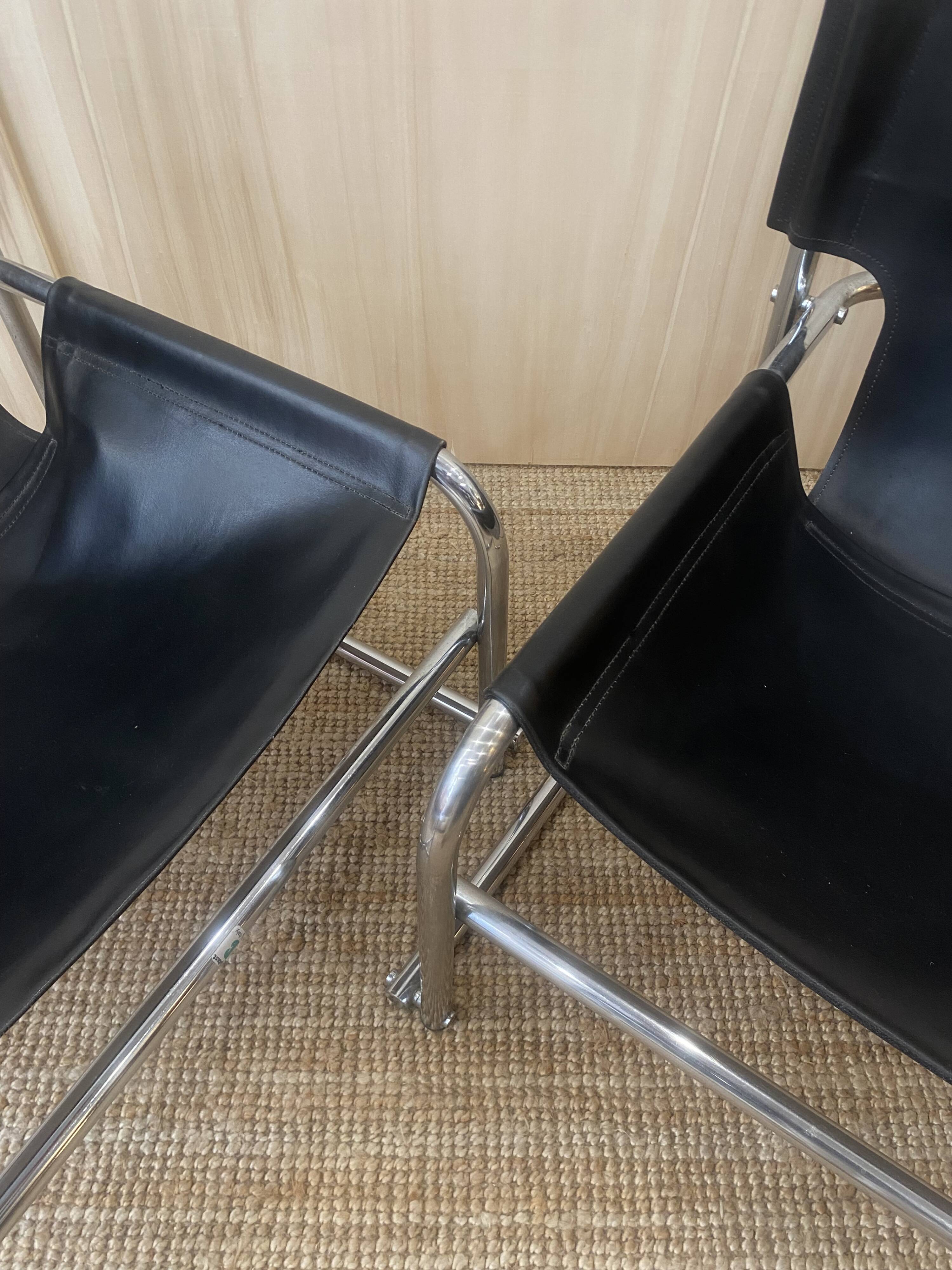 Black leather armchairs with a metal frame by Rodney Kinsman.