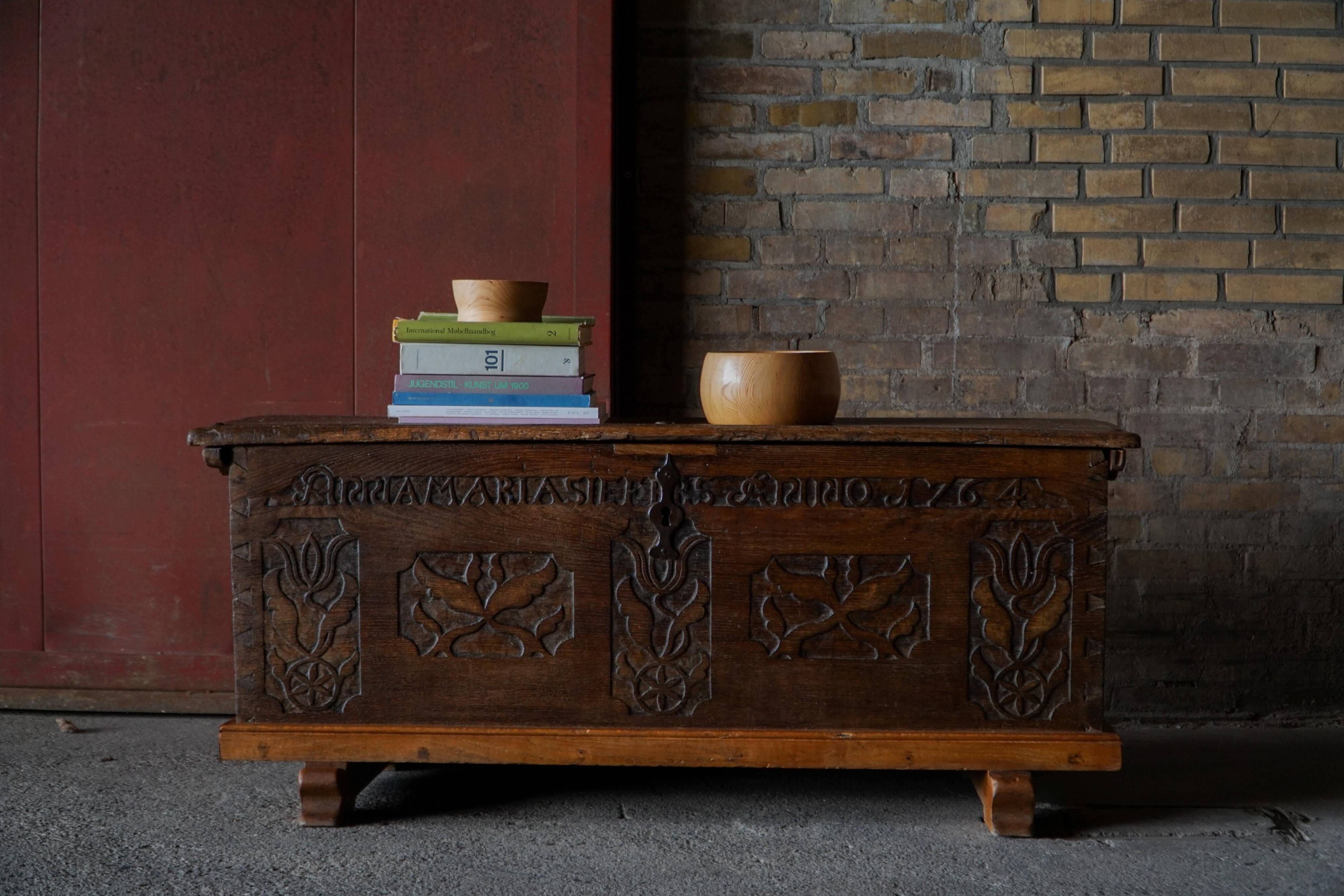 18th-century Scandinavian popular art oak chest with carved panels, dated 1764.