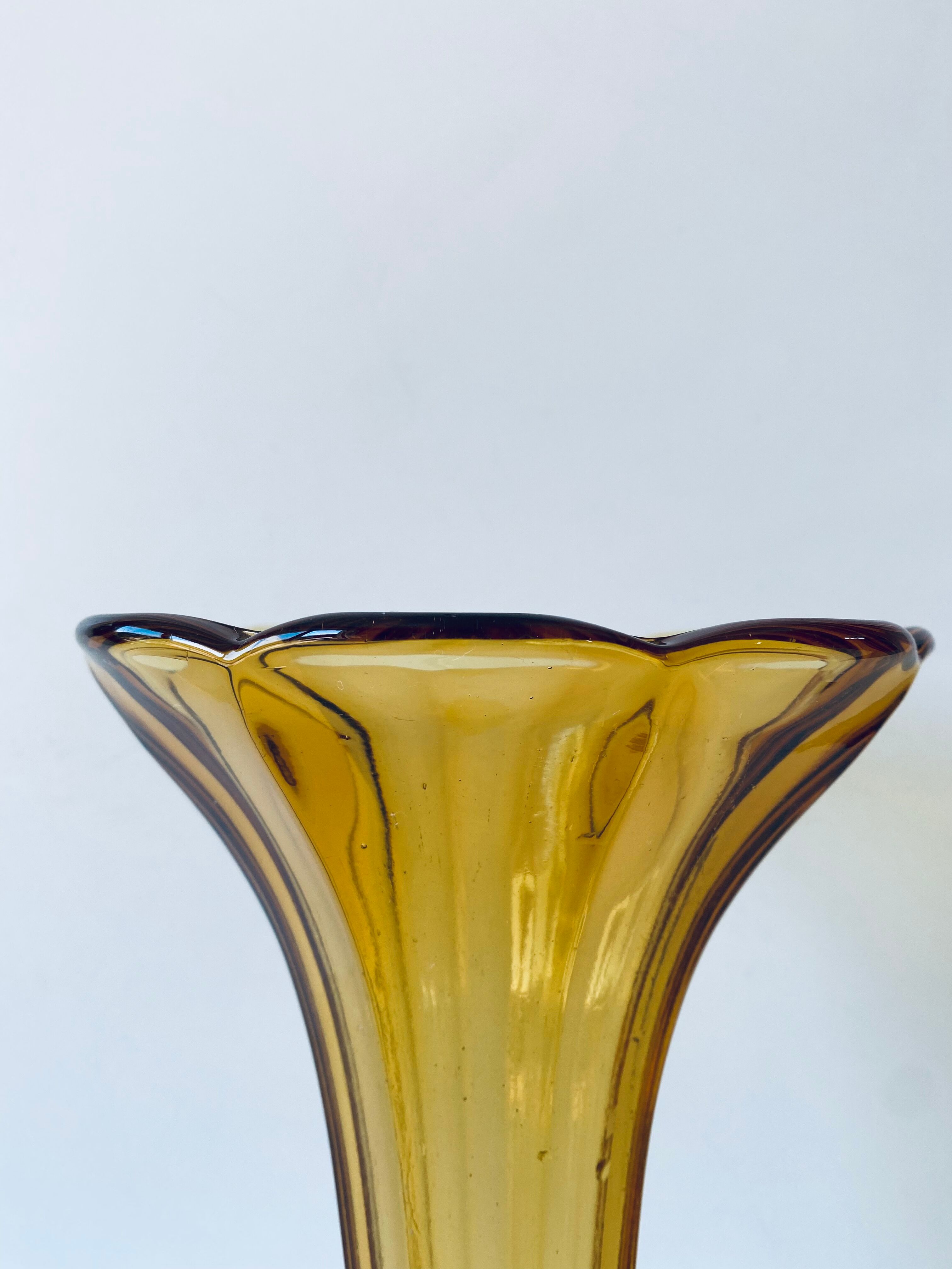 Ancient tulip vase in amber glass