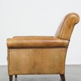 Stylish patinated vintage sheepskin armchair with a comfortable seat