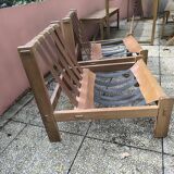 Pair of solid wood and leather lounge chairs, European work, circa 1970.