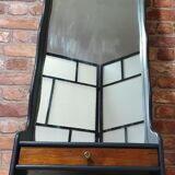 A renovated mirror in a wooden frame with a drawer and a shelf