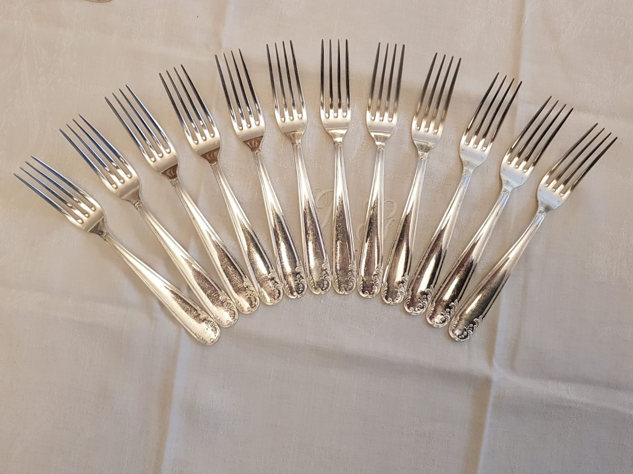 Silver cutlery set for 36 place settings and its ladle.
