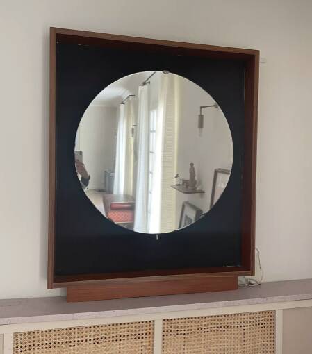 Scandinavian mirror with wooden frame and backlighting.