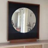 Scandinavian mirror with wooden frame and backlighting.