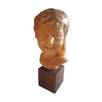 Child's head in wax on wooden base