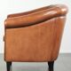 Vintage sheepskin club armchair with a warm colour scheme with black piping