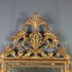 Antique gilded wooden mirror with rococo patterns, Italy, 18th century.